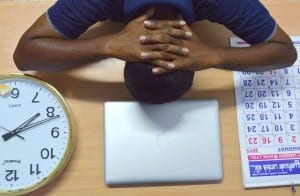 Man with high stress, head down on the desk