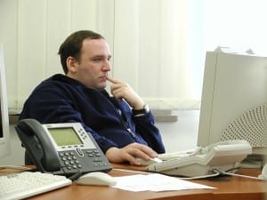 The man is working with an old computer.