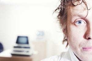 White Man with half face on screen