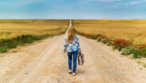 Lady walking path alone that indicates turnover.